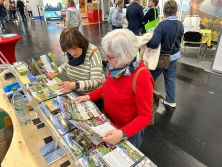 Prospektpräsentation am Messestand Urlaub in den Alpen