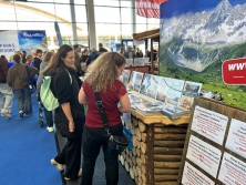 Prospektpräsentation am Messestand Urlaub in den Alpen