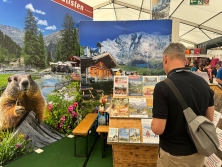 Prospektpräsentation am Messestand Urlaub in den Alpen