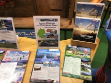 Prospektpräsentation am Messestand Urlaub in den Alpen