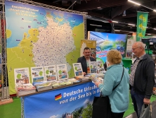 Prospektpräsentation am Messestand Urlaub in Deutschland