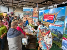 Prospektpräsentation am Messestand Urlaub in den Alpen