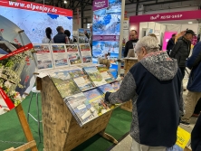 Prospektpräsentation am Messestand Urlaub in den Alpen