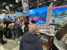 Prospektpräsentation am Messestand Urlaub in den Alpen