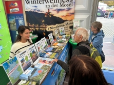 Prospektpräsentation am Messestand Urlaub in Deutschland
